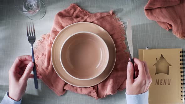 a Restaurant Visitor is Waiting for Food to Be Brought to Him alt