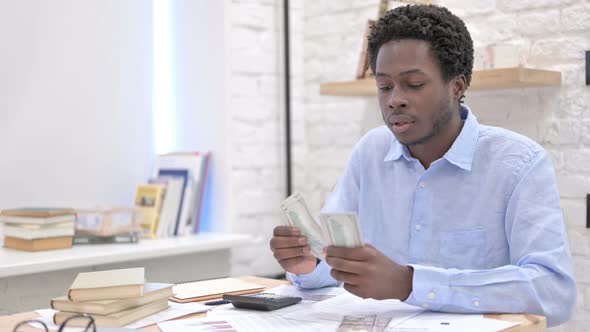 African Man Working With Money and Separating alt