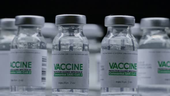 Vials of Vaccine for COVID19 Coronavirus Cure Are Slowly Rotated in Research Lab alt