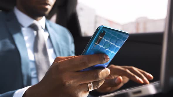 African American Businessman Rides in Car with Laptop alt