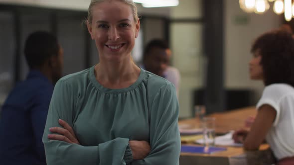 Portrait of caucasian businesswoman in a meeting room looking to camera smiling alt