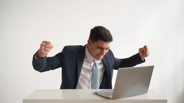 Happy Office Worker Works at Laptop and Funny Rejoices at Successful Deal alt