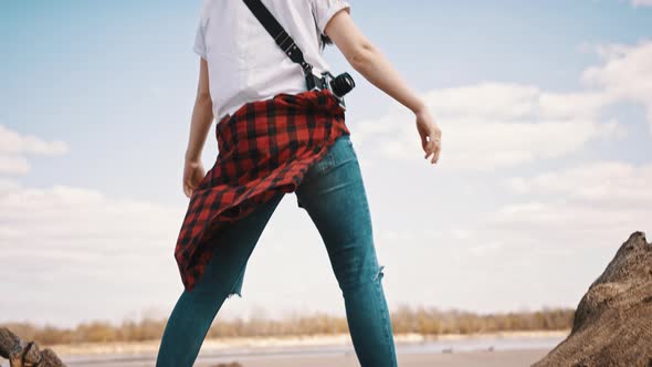 Happy Young Woman with Outstretched Hands Enjoying Sunny Day. Bright Blue Sky with Clouds in the alt