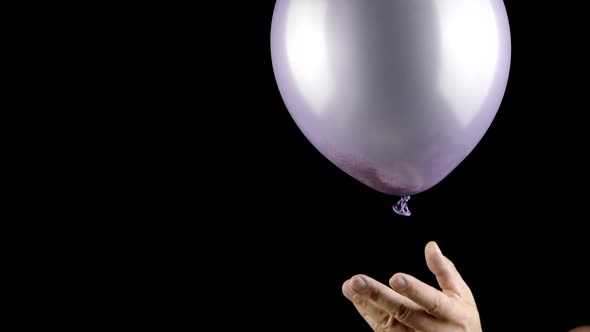 Balloon Burst in Slow Mo, Golden Glitter Confetti Explosion on Black Background