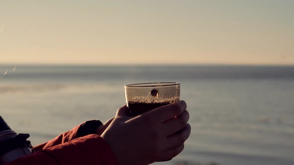 Traveler Enjoying Hot Tea In Mug On Forest Adventure. Refreshment From Thermos On Hiking At Cold. alt