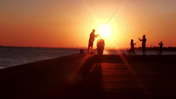 People fishing in sunset alt