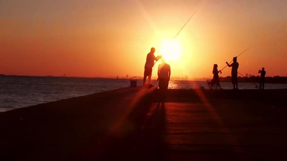 People fishing in sunset