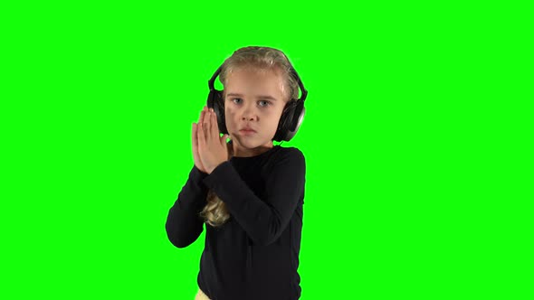 Cute Blond Girl Listening to Music and Clap Hands in Tact