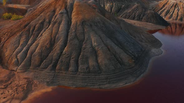Aerial View of a Landscape Similar To the Planet Mars with Red Hills and Rivers with Red Water alt