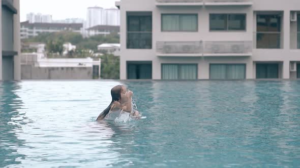 Daddy and Little Girl Play in Hotel Pool Water Slow Motion alt