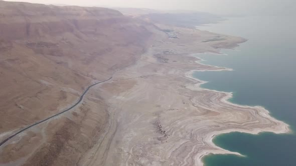 Aerial view of the Dead Sea and the surrounding cliff from the desert alt