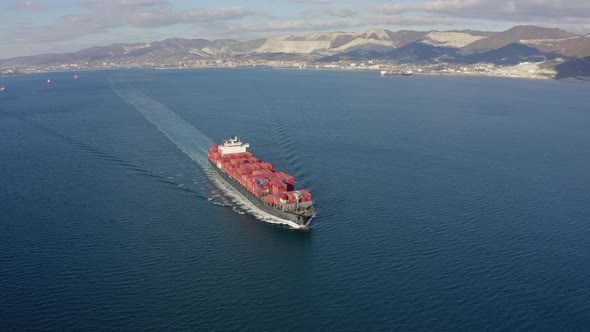 Ultra Large Container Ship Sailing at Sea Aerial Front View Footage alt