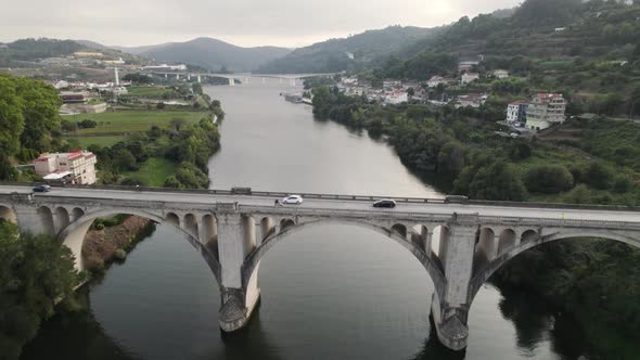 Aerial forward view over a bridge in Entre Os Rios. Portugal. Real time