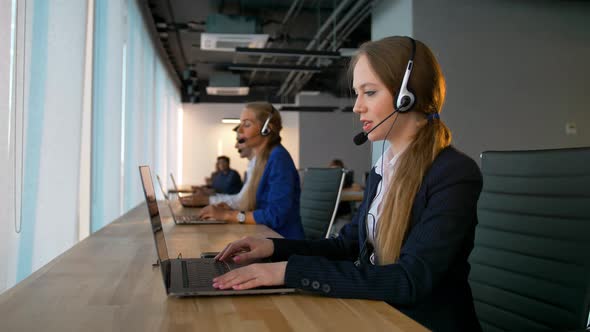 Call Center Business Woman Have Conversation with Customers and Looking at Camera alt