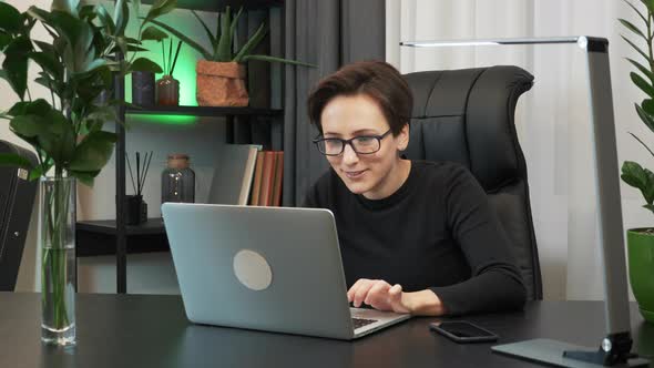 Woman is celebrating good news received by email. Woman is excited with good financial results alt