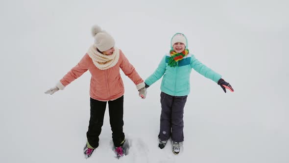 Mom and Daughter Have Fun in the Winter - Fall on Pure Snow alt