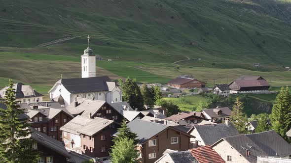 Swiss Village with a Church at the Foot of the Alps. Fascinating Picture.