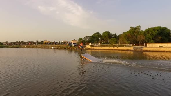 Aerial drone view of a man kiteboarding on a kite board alt
