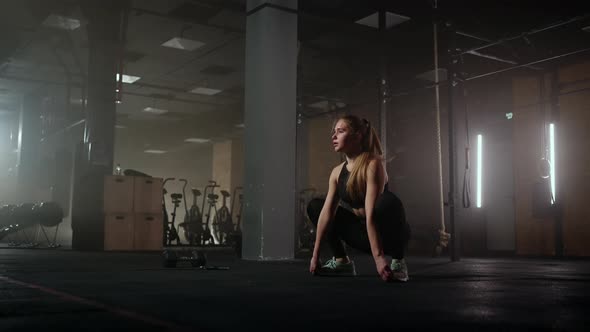 A Young Slender Woman Prepares and Warms Up Before Training alt