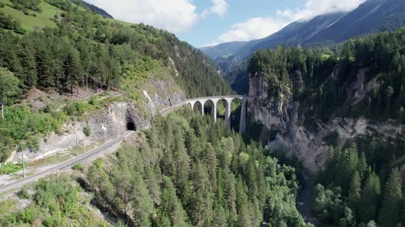 Landwasser Viaduct in Swiss Alps in Summer Aerial View on Green Mountain Valley alt