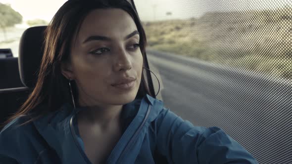 Female Passenger Looking Through Window alt