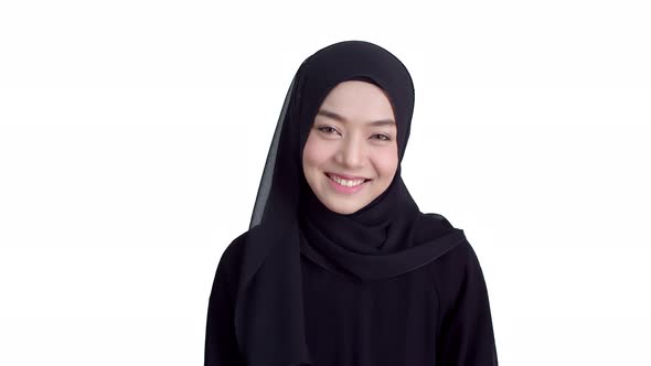 Portrait beautiful Muslim woman wearing traditional clothing and hijab toothy
