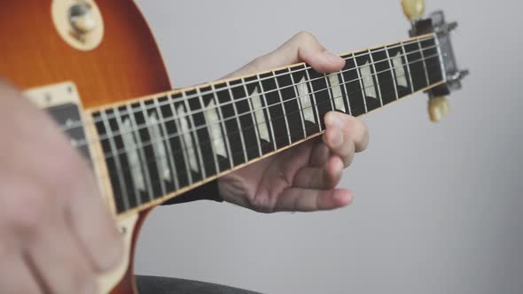 Guitarist playing solo on electric guitar. Rock solo on guitar musical instruments close up. alt