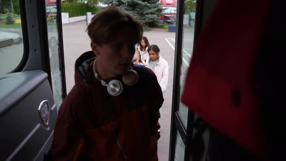 Multiracial Pupils Climbing Steps Getting on Bus alt