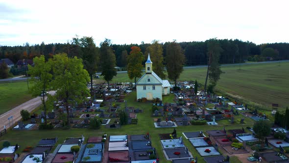 Aerial View Of Cemetery And Chapel In Lithuania During Summer. drone pullback alt