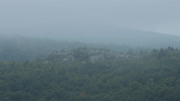 Lions Head rock formation seen through clouds from the Rohrbaugh Cliffs in the Dolly Sods Wilderness alt
