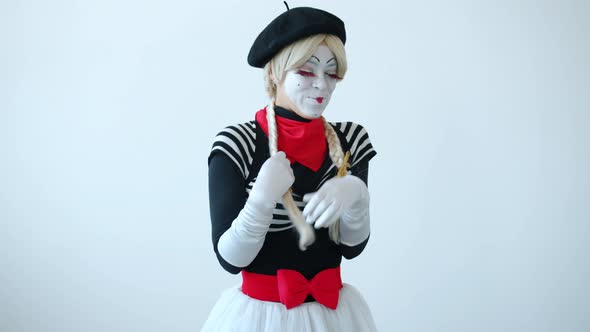 Slow Motion of Shy Girl Mime Touching Hair Smiling and Winking Looking at Camera alt