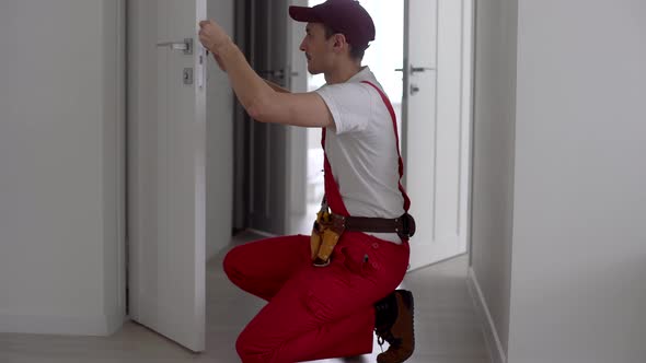 The Master Adjusts the Fittings in the Doors alt