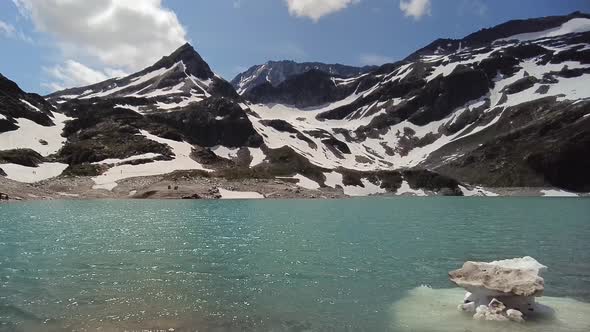 Walking towards a beautiful blue lake with snow and ice in the Austrian Alps, Uttendorf Weissee alt