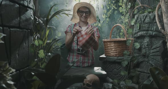 Funny tourist having a picnic in the jungle