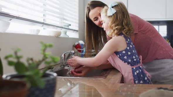 Caucasian mother and daughter having fun cooking together alt