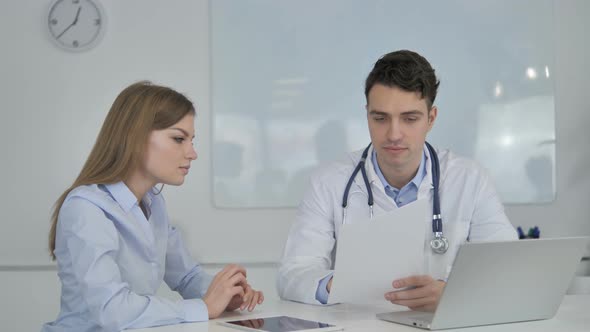 Doctor Sharing Good News with Patient, Holding Medical Report alt