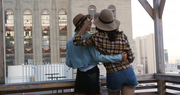 Young adult friends hanging out on a rooftop alt