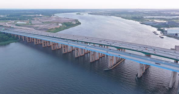 Aerial Down View of Cars Moving Along the Bridge Across River alt