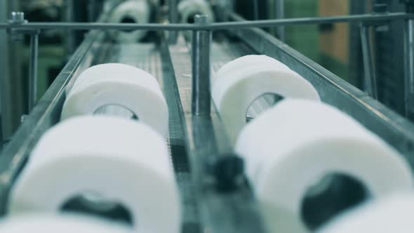 Close Up Shot of Toilet Paper Moving Along the Conveyor at a Paper Plant alt
