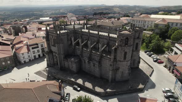Dramatic architecture of Guarda Cathedral in Portugal; drone orbit
