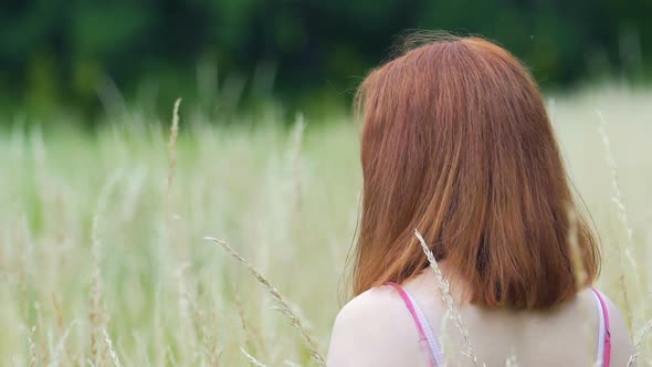 Red Haired Woman Looks Around to Camera Outdoors, Slow Motion Beautiful Lady alt