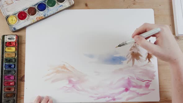 Timelapse of artist painting landscape with watercolors alt
