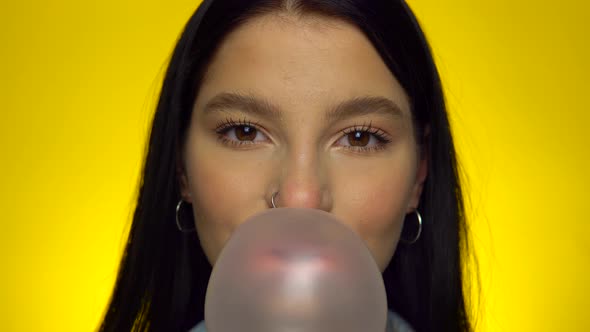 Attractive Woman Looking at Camera Blowing Bubble Gum Smiling Female Portrait