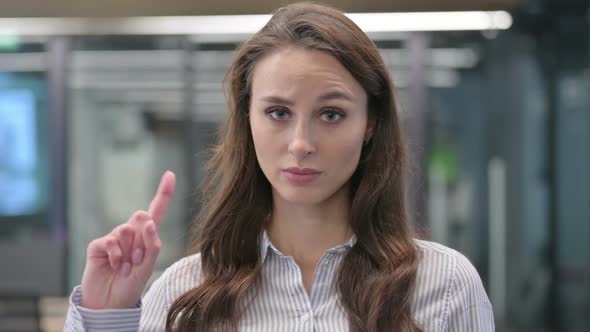 Portrait of Young Businesswoman showing No Sign by Finger alt