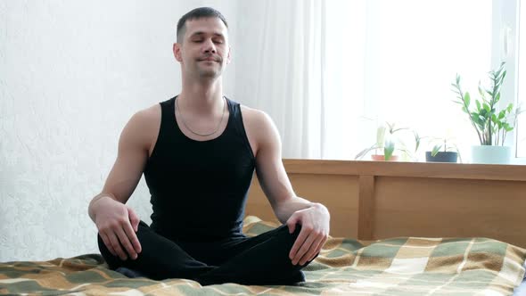 Young Guy Is Enjoying Meditation at Home