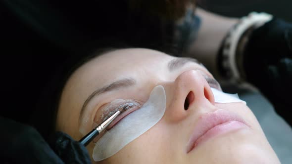 Beauty Treatment. Beautician Put a Solution on Curler Eyelash Curler. Botox and Lash Lamination