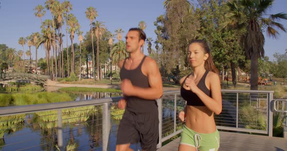 Athlete Couple Jogging In The Park alt