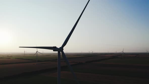 Silhouettes of Wind Turbines with Rotating Propeller Blades alt
