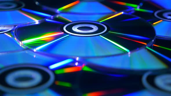 Many Compact Discs Lying On Top Of Each Other Rotate 2