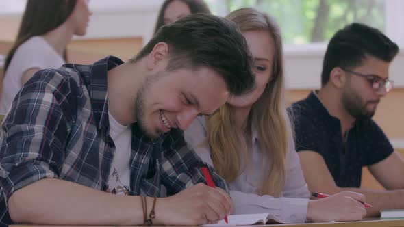 Groupmates Having Fun in University. alt